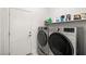 Bright laundry room with modern washer and dryer units and plenty of shelf space at , Pahrump, NV 89061