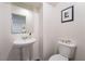 Half bathroom featuring a pedestal sink, toilet, and decorative wall art at 1109 Scarlet Sparrow St, Henderson, NV 89011