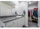 Bathroom vanity with granite counters, sink, walk in closet, and large mirror at 1109 Scarlet Sparrow St, Henderson, NV 89011