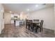 Open dining area featuring a modern kitchen and dark wood dining set at 1109 Scarlet Sparrow St, Henderson, NV 89011