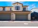 Attractive townhome with a two-car garage, charming architectural details, and well-maintained landscaping at 1109 Scarlet Sparrow St, Henderson, NV 89011