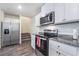 Bright kitchen featuring stainless steel appliances, granite countertops, and ample cabinet space at 1109 Scarlet Sparrow St, Henderson, NV 89011