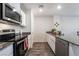 Well-lit kitchen with stainless steel appliances, granite counters, and modern white cabinetry at 1109 Scarlet Sparrow St, Henderson, NV 89011