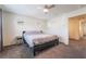 Bright main bedroom featuring plush carpet, neutral paint, ceiling fan, and natural light at 1109 Scarlet Sparrow St, Henderson, NV 89011