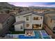 An aerial view of the modern home, featuring a backyard with a swimming pool, spa, and outdoor fire pit at 11991 Rockview Point St, Las Vegas, NV 89138