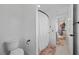 This light and airy bathroom features white walls, a shower with a curtain, and stylish rugs at 11991 Rockview Point St, Las Vegas, NV 89138