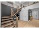 Modern staircase with wood steps, black rails, and an open floor plan design at 11991 Rockview Point St, Las Vegas, NV 89138