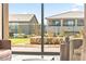 View of the backyard and neighboring houses from inside the living room at 12103 Canyon Sunset St, Las Vegas, NV 89138