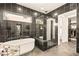 Luxurious bathroom featuring a sleek soaking tub, glass shower, and walk in closet at 12103 Canyon Sunset St, Las Vegas, NV 89138