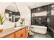 Spa-like bathroom featuring modern tile, a soaking tub, and a large mirror at 12103 Canyon Sunset St, Las Vegas, NV 89138