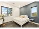 Bright bedroom with a modern design, featuring a white bed frame and large windows for natural light at 12103 Canyon Sunset St, Las Vegas, NV 89138