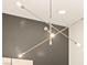 Stylish, modern chandelier with exposed bulbs against a gray accent wall at 12103 Canyon Sunset St, Las Vegas, NV 89138