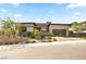 Contemporary home with clean lines, desert landscaping, and modern garage door at 12103 Canyon Sunset St, Las Vegas, NV 89138