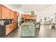 View of the kitchen with an expansive island, cabinets, and dining area at 12103 Canyon Sunset St, Las Vegas, NV 89138