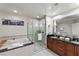 Modern bathroom featuring a shower, large soaking tub, and double sink vanity with plenty of lighting at 125 E Harmon Ave # 216, Las Vegas, NV 89109