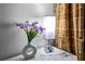 Charming vignette featuring a modern vase with purple flowers and stylish lamp at 125 E Harmon Ave # 216, Las Vegas, NV 89109