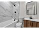 Bathroom features a tub and shower combination with stylish tile and modern fixtures at 1820 Montvale Ct, Las Vegas, NV 89134