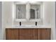 Modern double vanity with illuminated mirrors and sleek wood cabinetry at 1820 Montvale Ct, Las Vegas, NV 89134