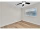 Cozy bedroom with wood-look floors, white walls, and a bright window at 1820 Montvale Ct, Las Vegas, NV 89134