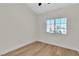 Sunny bedroom with wood floors, a neutral color palette, and a large window with blinds at 1820 Montvale Ct, Las Vegas, NV 89134