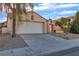 Charming single-story home with a tile roof, two-car garage, and desert landscaping at 1820 Montvale Ct, Las Vegas, NV 89134