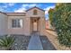 Inviting front entrance with desert landscaping, a covered porch, and a bright white front door at 1820 Montvale Ct, Las Vegas, NV 89134