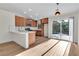 Bright kitchen with wood cabinets, modern appliances, and a sliding door leading to the backyard at 1820 Montvale Ct, Las Vegas, NV 89134