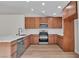 Stylish kitchen featuring wood cabinets, stainless steel appliances, and white marble countertops at 1820 Montvale Ct, Las Vegas, NV 89134