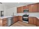 Well-equipped kitchen with wood cabinets, stainless steel appliances, and marble countertops at 1820 Montvale Ct, Las Vegas, NV 89134