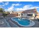 Private kidney-shaped pool surrounded by desert landscaping and the home's backyard elevation at 1820 Montvale Ct, Las Vegas, NV 89134