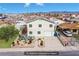 A two-story home with enhanced landscaping, featuring desert plants and vibrant flowers, giving a welcoming curb appeal at 1912 Margarita Ave, Henderson, NV 89011