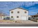 A two-story home with neutral stucco, an attached garage, and a tidy front yard under a bright, partly cloudy sky at 1912 Margarita Ave, Henderson, NV 89011