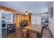 Bright kitchen features stainless appliances, gray cabinetry, and a rustic wood dining table at 1912 Margarita Ave, Henderson, NV 89011