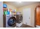 Convenient laundry room includes a washer, dryer and lots of storage space for detergents and cleaning supplies at 1912 Margarita Ave, Henderson, NV 89011