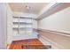 Bright walk-in closet with built-in shelving and wooden floors at 1912 Margarita Ave, Henderson, NV 89011