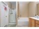 Bright bathroom with a shower and a soaking tub for relaxation at 214 Roxborough St, Henderson, NV 89074