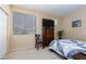 Bedroom with a large window, providing natural light, and a cozy blue patterned quilt at 214 Roxborough St, Henderson, NV 89074