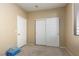 This bedroom has carpeted floors and a closet with sliding doors and an additional side door at 214 Roxborough St, Henderson, NV 89074