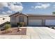 Inviting single-story home showcasing a two-car garage and desert landscaping at 214 Roxborough St, Henderson, NV 89074