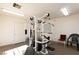 Bright gym with universal machine, neutral carpet, white walls and two chairs at 214 Roxborough St, Henderson, NV 89074