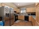 Well-lit kitchen featuring stainless steel appliances and light wood cabinetry at 214 Roxborough St, Henderson, NV 89074