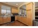 Cozy kitchen with wood floors, stainless steel appliances, and a bright window at 214 Roxborough St, Henderson, NV 89074