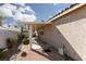 This patio is partially shaded and includes brick landscaping with some chairs outside of the house at 214 Roxborough St, Henderson, NV 89074