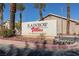 The Rainbow Villas sign is in front of the property with palm trees and rock landscaping at 214 Roxborough St, Henderson, NV 89074