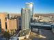 Las Vegas high-rise featuring a modern design, with a pool and palm trees on the lower level, set against a mountain backdrop at 2700 Las Vegas Blvd # 809, Las Vegas, NV 89109