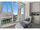 Relaxing chaise lounge and cityscape view in the well-appointed bedroom at 2700 Las Vegas Blvd # 809, Las Vegas, NV 89109