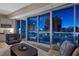 Living room with floor-to-ceiling windows showcasing city views, comfortable seating, and built-in shelves for storage at 2700 Las Vegas Blvd # 809, Las Vegas, NV 89109