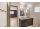 Updated bathroom with dual sinks, modern fixtures, and a view into an adjacent bedroom at 3314 El Camino Real, Las Vegas, NV 89121