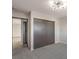 Carpeted bedroom with gray sliding door closet and view to the hallway at 3314 El Camino Real, Las Vegas, NV 89121