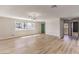 Bright and airy living room with wood floors, modern lighting, and a view of the front yard at 3314 El Camino Real, Las Vegas, NV 89121